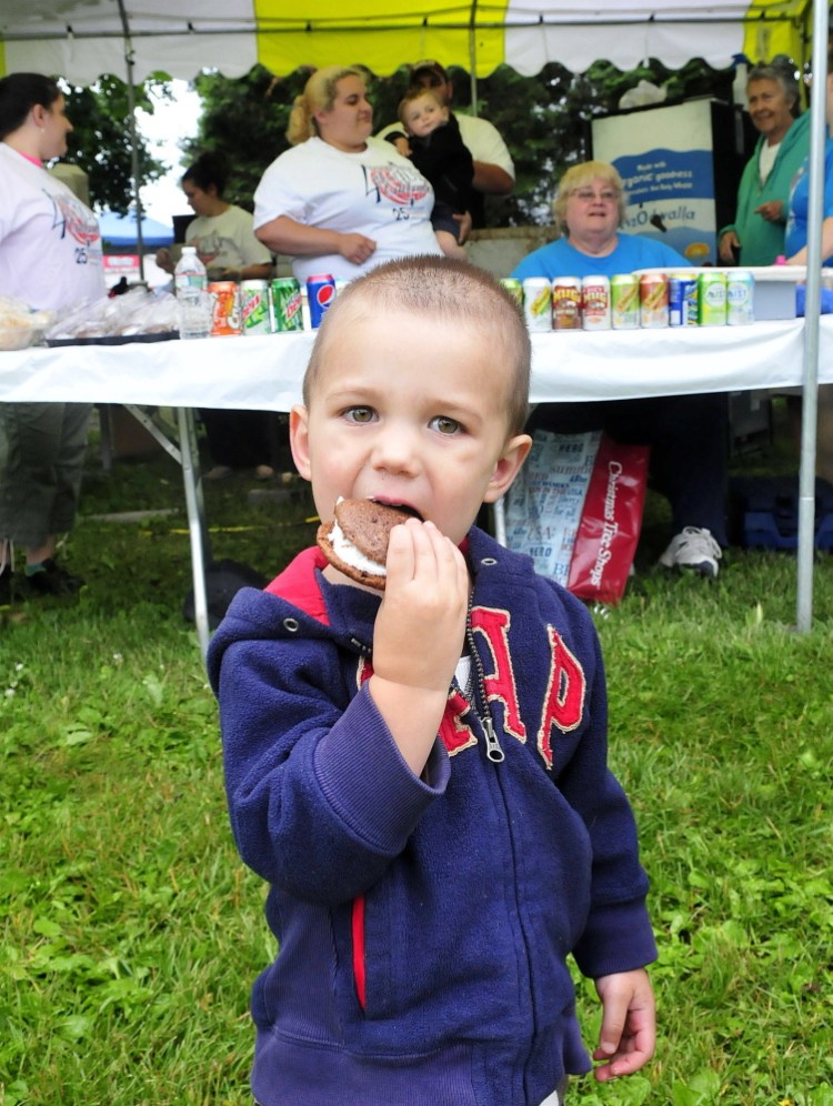 Connor Jones chomps down on a whoopie pie Wednesday donated by Hillman’s Bakery to the Winslow Family 4th of July concession stand at Fort Halifax Park in Winslow.