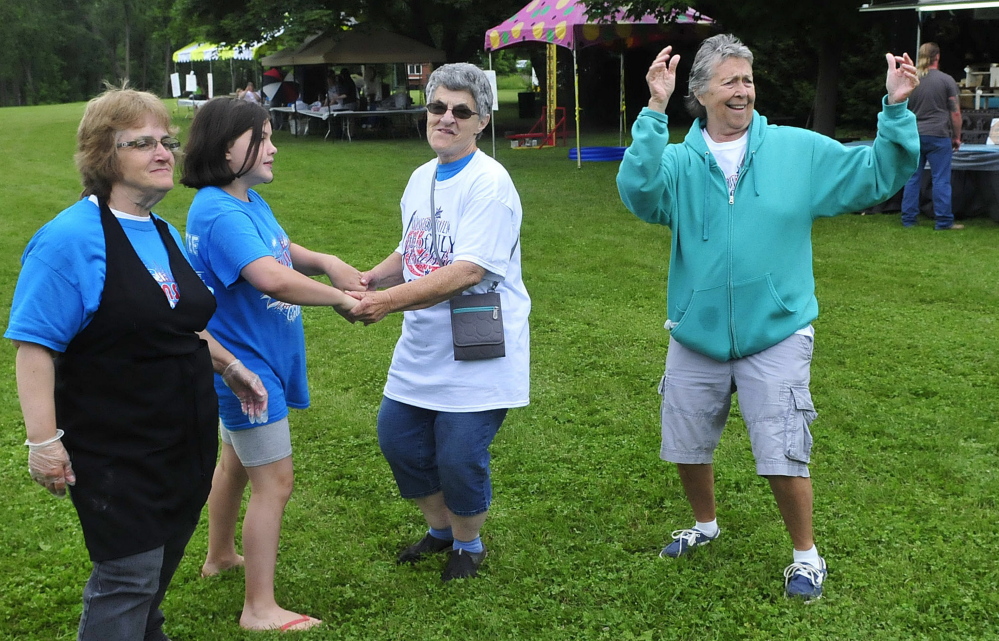 From left, Gail Poulin, Bayleigh Thibodeau, Joan Gaulin and Diane Ruff dance on Wednesday to music at the Fort Halifax park in Winslow.