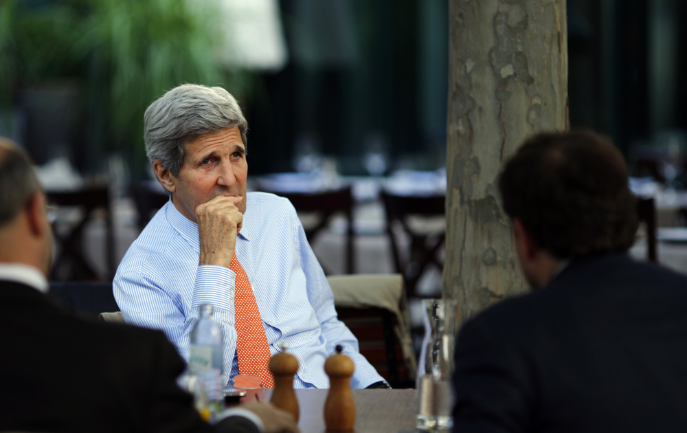 U.S. Secretary of State John Kerry, center, National Security Council point person on the Middle East Robert Malley, left, and Chief of Staff at the U.S. Department of State Jon Finer meet on the terrace of a hotel where the Iran nuclear talks meetings are being held in Vienna, Austria, Thursday.
