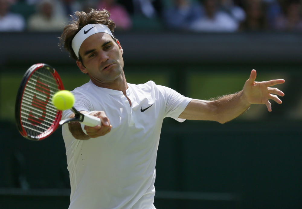 Roger Federer of Switzerland returns a shot to Sam Groth of Australia during their singles match at the All England Lawn Tennis Championships in Wimbledon, London, Saturday.