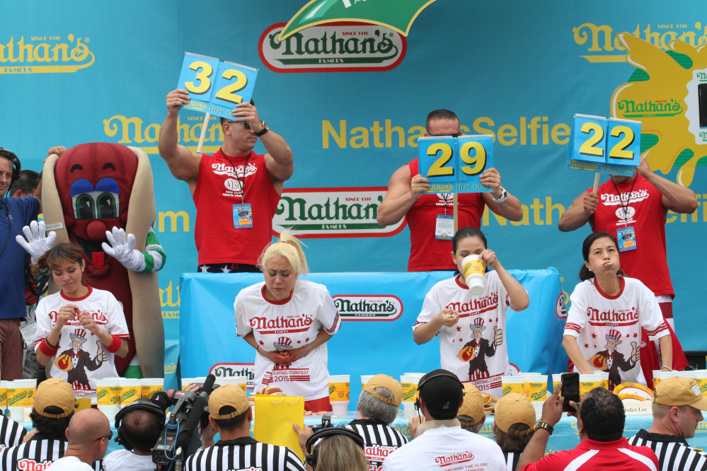 Competitors, including Miki Sudo, second from left, and Sonya “Black Widow”  Thomas, second from right, take part in Nathan’s Famous Fourth of July International Hot Dog Eating Contest women’s competition Saturday in the Coney Island section in the Brooklyn borough of New York.