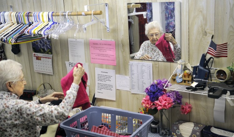 Volunteer Mary Pinkham, 93, folds clothing at the Clothes Closet Thursday in Gardiner.