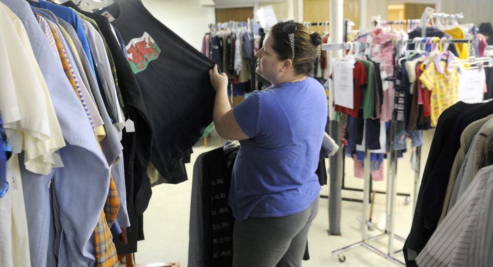 Shyanne Smart, of West Gardiner, shops for items at the Clothes Closet in Gardiner on Thursday.