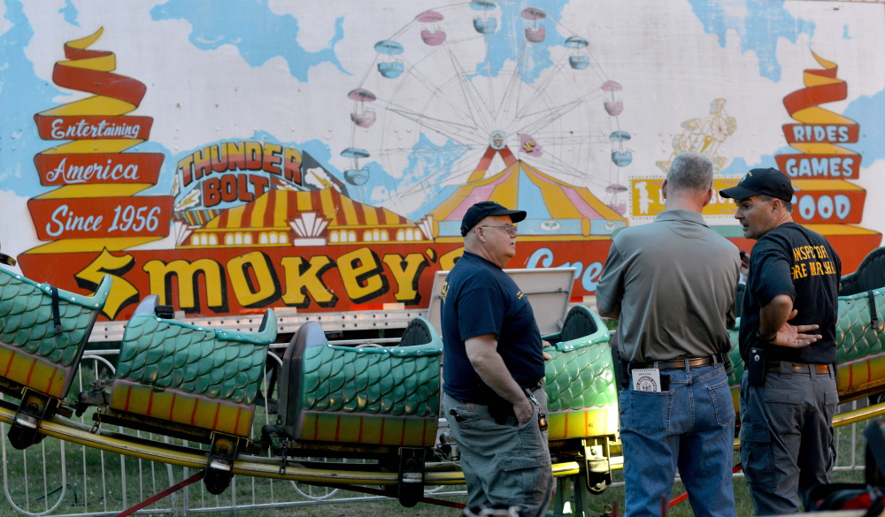 Inspectors from the Office of the State Fire Marshal investigate a ride malfunction of the Dragon Wagon at the Smokey’s Greater Show carnival at Head of Falls in Waterville on June 12. The Office of the State Fire Marshal on Monday charged Arthur Gillette, 49, of Pittsfield, Massachusetts, the carnival’s ride supervisor, with falsifying physical evidence because he “was attempting to repair or alter the physical condition of the ride before we were able to get there to investigate it,” according to Sgt. Ken Grimes.