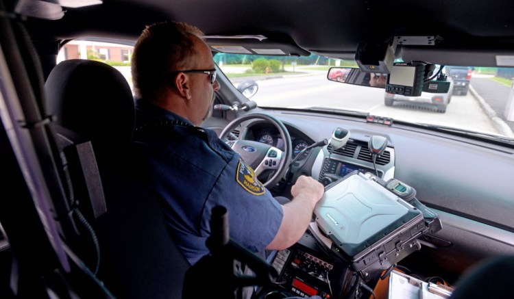 Officer Brett Lowell patrols outside the elementary school in Madison on June 5. Under a new contract, the town of Madison’s police officers now are part of the Somerset County Sheriff’s Office. The town has a one-year, $480,728 contract for police services.