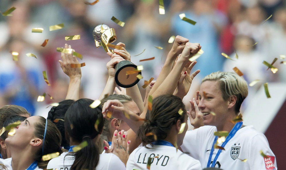 United States players Carli Lloyd and Abby Wambach, right, embrace as the team celebrates their championship win over Japan in the FIFA Women’s World Cup on Sunday in Vancouver, British Columbia, Canada.