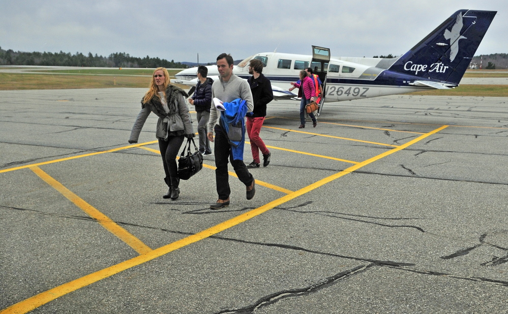 Passengers arriving from Boston walk toward the terminal at the Augusta State Airport in November 2014.