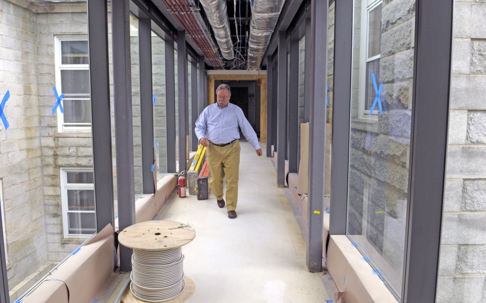 Kennebec County Administrator Robert Devlin walks through a new glassed-in walkway inside the courtyard of the old Kennebec County Courthouse in Augusta on Thursday.