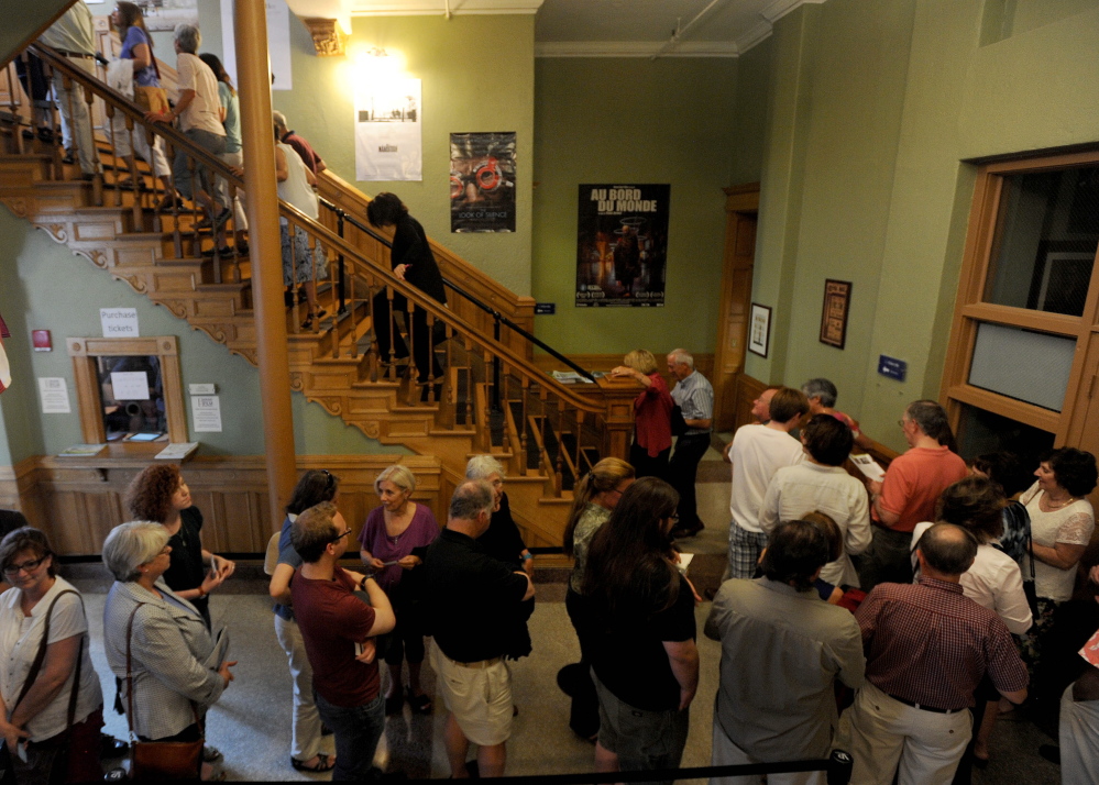 People wait in line Friday night in the Waterville Opera House hallway for the movie “Tumbledown” to kick off the opening night of the Maine International Film Festival in Waterville.