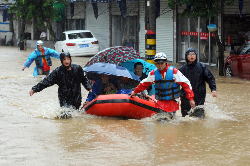 Rescuers use an inflatable boat to evacuate residents from a neighborhood flooded by heavy rains from Typhoon Chan-Hom in Shaoxing in eastern China’s Zhejiang province on Saturday. Some 1.1 million people were evacuated from coastal areas of Zhejiang and more than 46,000 in neighboring Jiangsu province ahead of the storm.
