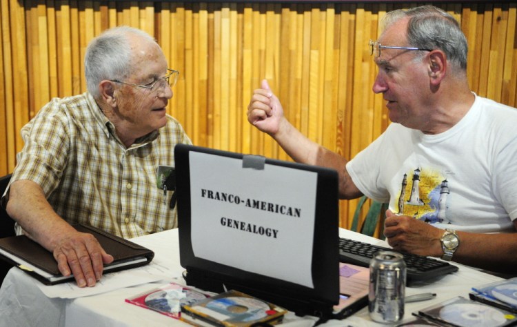 Eugene Moreau, left, of Farmingdale, gets advice from genealogy consultant Bob Chenard on Saturday during the 2015 Maine Genealogy Fair in the Maine State Cultural Building in Augusta.