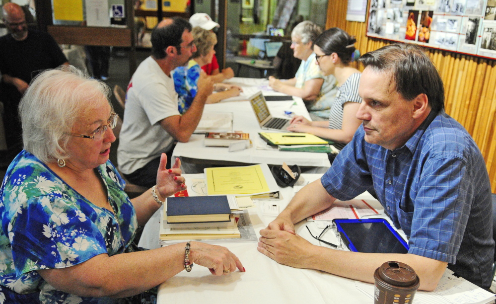 Lorna Fanjoy, left, of Auburn, gets advice from genealogy consultant Craig Siulinski on Saturday during the 2015 Maine Genealogy Fair in the Maine State Cultural Building in Augusta.