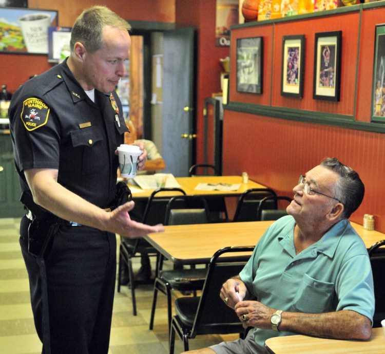 New Winthrop Police Chief Ryan Frost chats with Carl Flagg, of Falls Township, Pennsylvania, at the Full Court Deli after being sworn in earlier on Tuesday at the Winthrop Town Office. Flagg graduated from Winthrop High School in 1952 and was back for a class reunion this week. The new chief said that he likes to get out of the office and meet people.