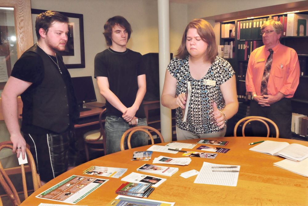 Sarah Graettinger, center right, and Ben Tucker, right, representatives from U.S. Sen. Angus King’s office, give pamphlets and information on education to Tristan Huntoon, left, of Madrid, and Nick Pelletier, of Bingham, during an outreach program visit Tuesday at the Farmington Public Library.
