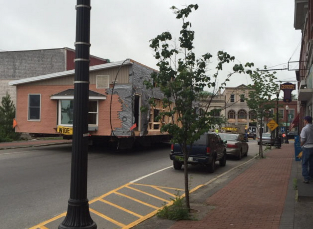 A portable building is moved at 6:30 a.m. Wednesday down Madison Avenue in Skowhegan. The building was on its way to the campus of Skowhegan Area High School, where it will house the new Kennebec Valley Community Action Program early-childhood center. Another portion of the building will be moved Friday morning.