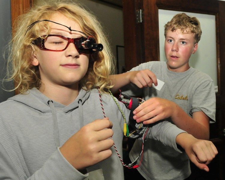 Caleb Hodsdon, left, of Wilton, tries out the sensory device he and Keegan Austin, of Rangeley, made Wednesday during Creative Tech Summer Camp at the University of Maine in Farmington.