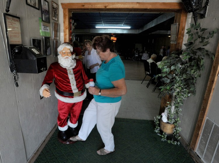 Shirley Phillips, a Christmas in July volunteer for the past 22 years, turns on Santa Claus on Thursday for the annual celebration at Melody Ranch in Fairfield.