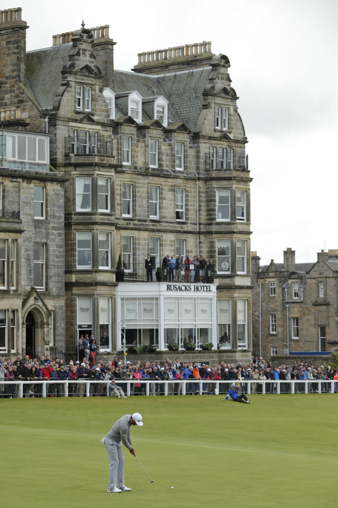 Dustin Johnson putts on the 18th green during the first round of the British Open Golf Championship at the Old Course, St. Andrews, Scotland, Thursday.