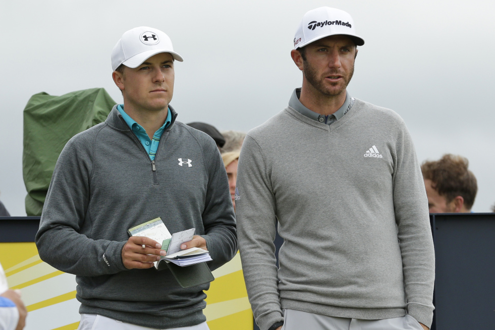 Jordan Spieth, left, and Dustin Johnson speak before playing from the 15th tee during the first round of the British Open Golf Championship at the Old Course, St. Andrews, Scotland, Thursday.