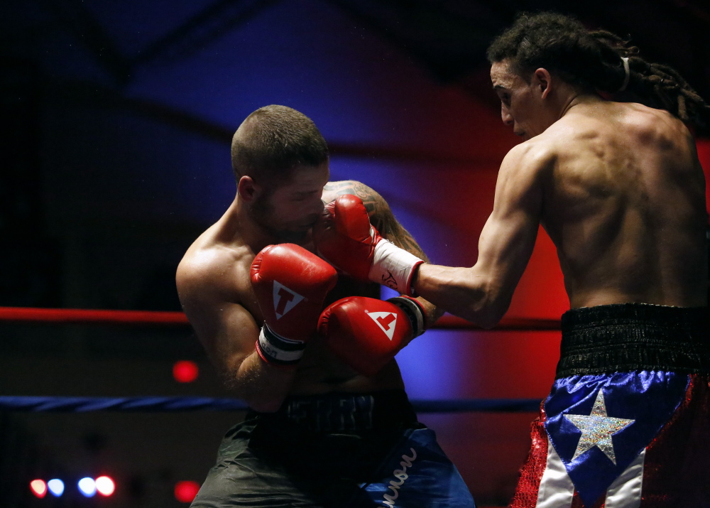 Portland Press Herald photo by Derek Davis 
 Freddie Sanchez, of Worcester, Mass., lands a punch on Brandon Berry, of West Forks, during a light welterweight bout at the Portland Expo last November.