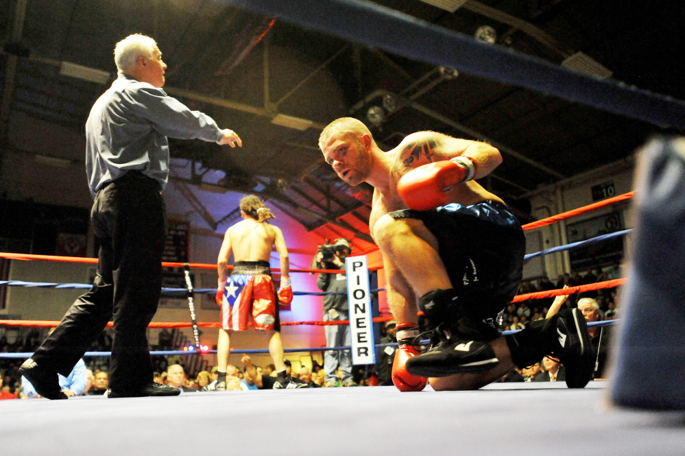 Staff file photo by Michael G. Seamans 
 Brandon Berry, right, kneels in the ring at the Portland Expo after losing by TKO to Freddy Sanchez, of Worcester, Mass.,  in the third round of a fight last November.
