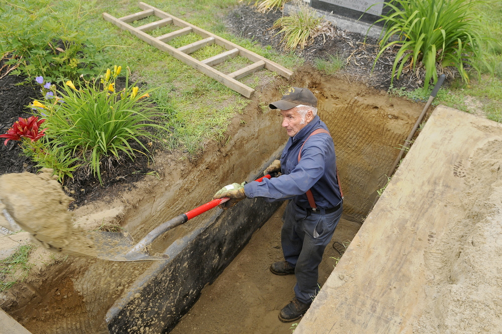 Litchfield Plains Cemetery caretaker Donald Vannah digs a grave Tuesday at the cemetery. Each plot takes up to five hours to excavate by hand, he said.