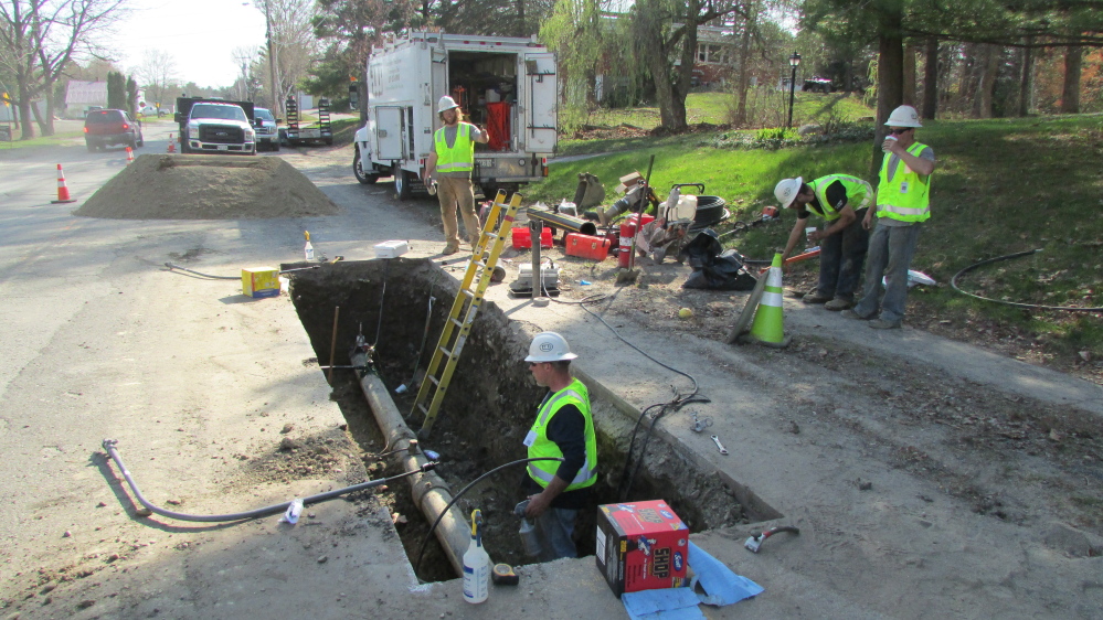 Employees from ETTI, a utilities construction company from Lisbon Falls, replace an electrofusion tee on a Summit Natural Gas line in April on Cool Street in Waterville. Another subcontractor improperly installed 66 percent of the tees in Waterville, Fairfield and Madison, and ETTI is replacing them.
