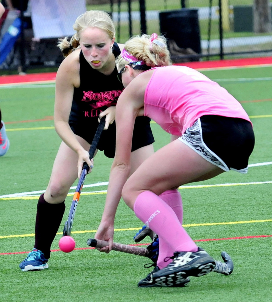 Hannah Merservey, left, of Nokomis and Lauren Leblanc, of Skowhegan, battle for the ball during a field hockey fundraiser event at Thomas College in Waterville on Saturday. 