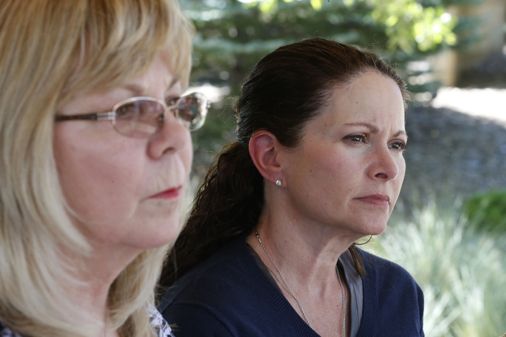 Caren Teves, right, who lost her son Alex in the 2012 Aurora movie theatre massacre, sits with her friend Sandy Phillips, left, whose daughter Jessica Ghawi was killed in the attack, during an interview with The Associated Press, at a park near the Arapahoe County District Court, in Centennial, Colo.