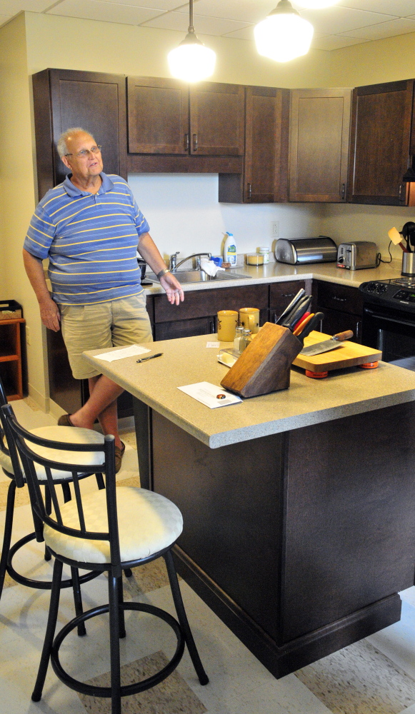 Resident Jim “Whit” Whitten talks on Wednesday in his new apartment in the Cony Flatiron Senior Residence in Augusta.
