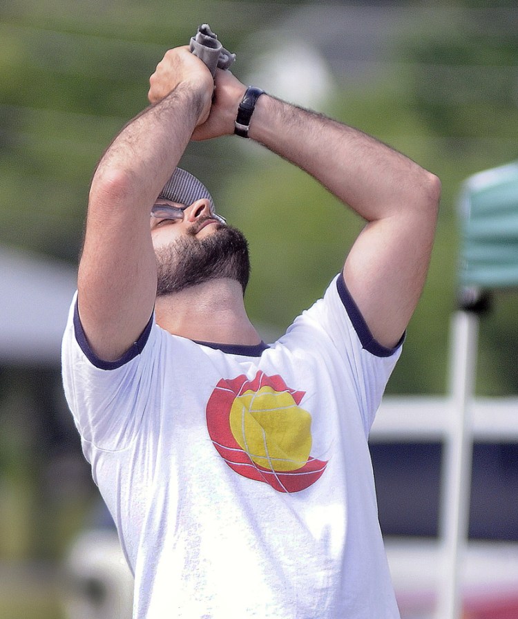 Stephen Lessard reacts to his throw of a petanque ball Sunday during an annual tournament in at Mill Park in Augusta.