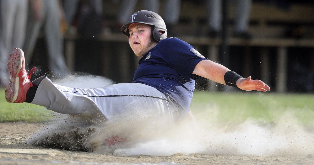 Staff photo by Andy Molloy 
 Augusta's Taylor Lockhart slides into home during an American Legion game against Farmington on Tuesday. Both teams will open tournament play this week.