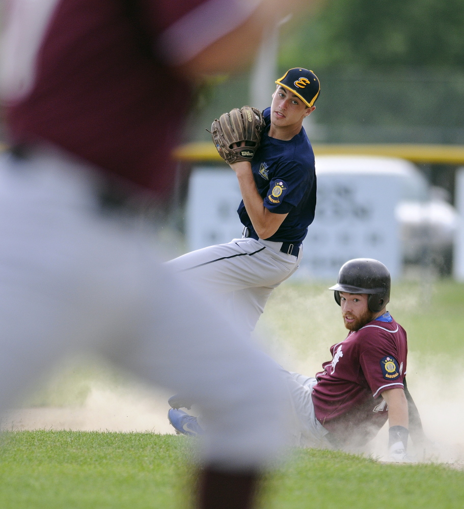 Staff photo by Andy Molloy 
 Augusta's Ryan Rodrigue can't turn a double play as Farmington's Andrew Pratt slides into second during an American Legion game in Augusta last week. Augusta and Farmington open tournament play this week.