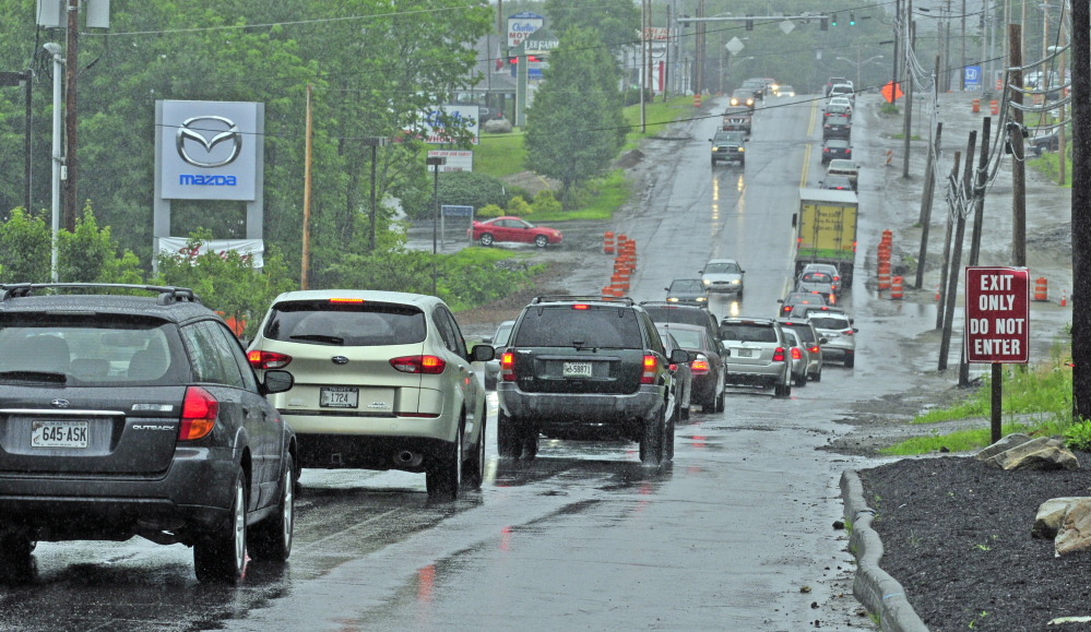 This file photo taken July 16, 2014, shows eastbound Western Avenue traffic near the intersection of Woodside Road in Augusta, where a woman hit a pothole while riding her motorcycle and died nine days later.
