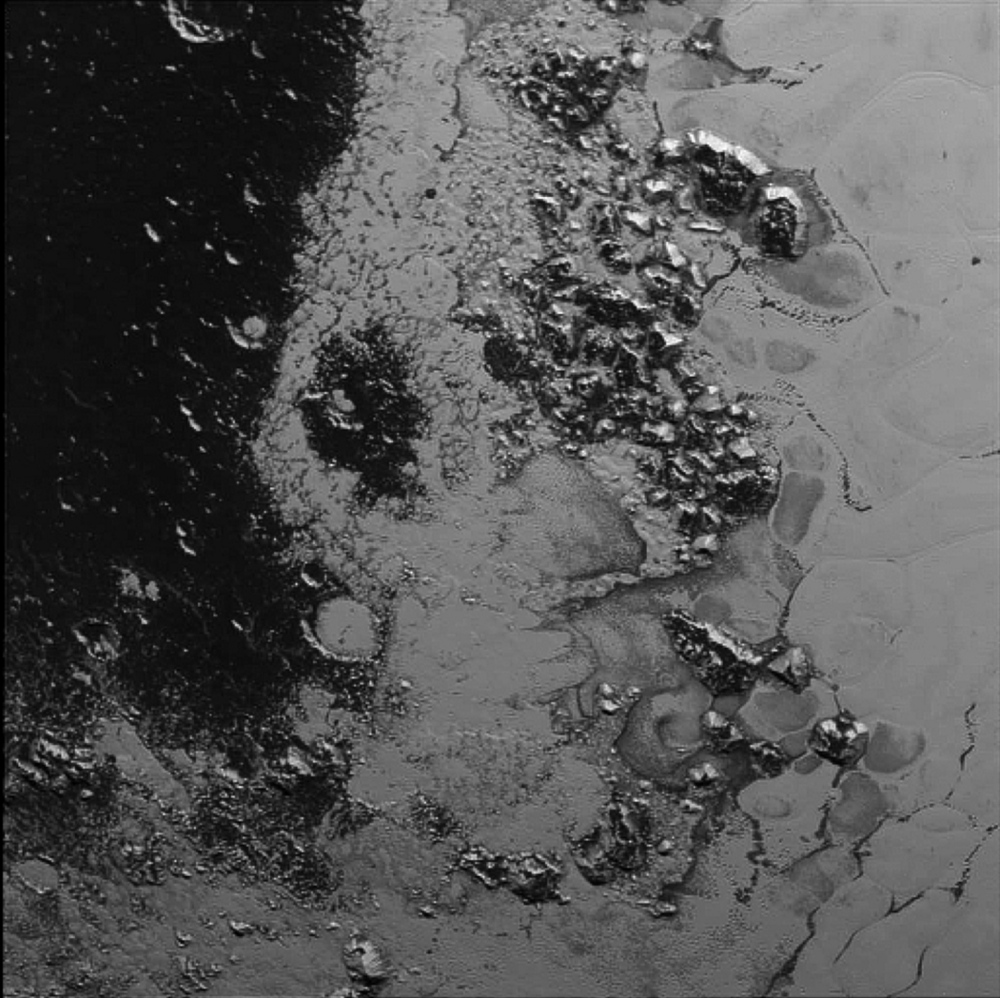 In this photo taken by New Horizons on July 14 from a distance of 48,000 miles, features as small as a half-mile across are visible on the surface of Pluto. The frozen mountain peaks are estimated to be one-half mile to one mile high, about the same height as the Appalachian Mountains.
