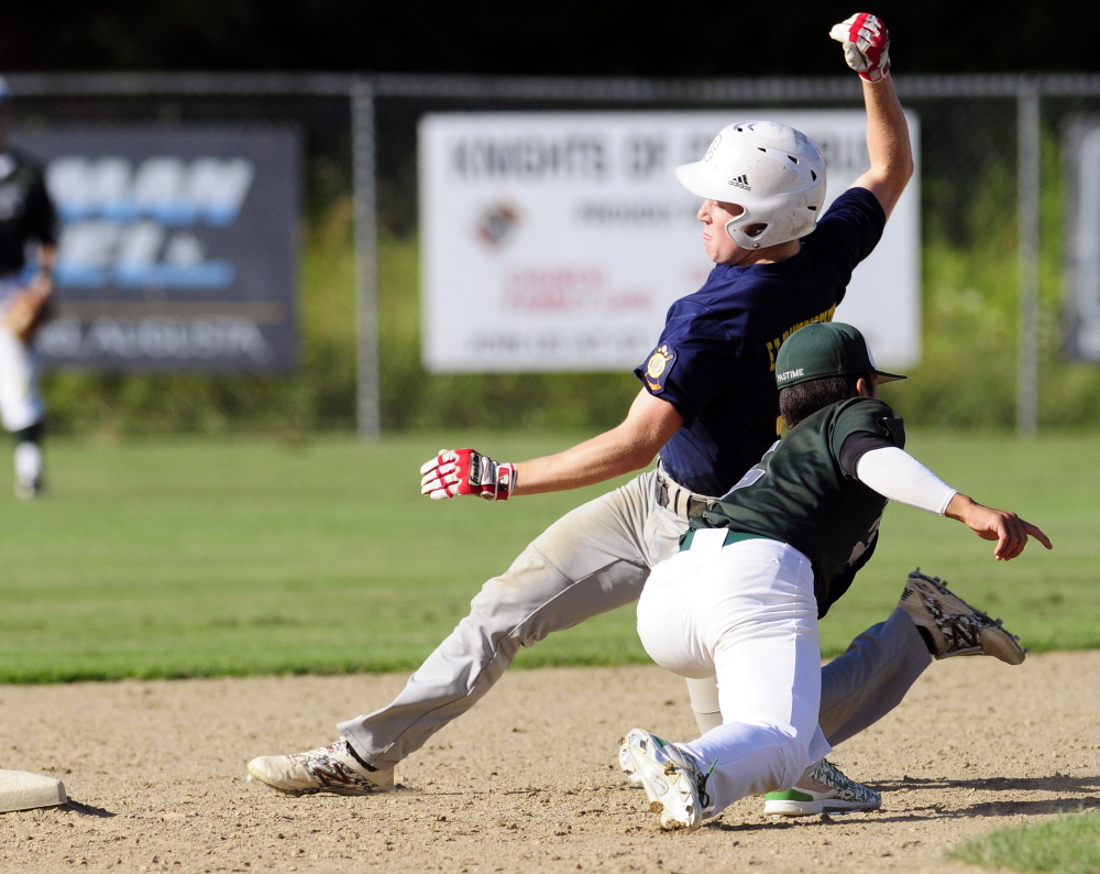 Staff photo by Joe Phelan 
 Augusta Elks baserunner Connor Perry is tagged out at second base by Pastime second baseman Mike Wong during a Zone 2 playoff game Wednesday on McGuire Field in Augusta. Augusta won 5-3.