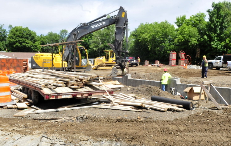Construction workers build the foundation for the new Newport public safety building on Water Street on Monday.