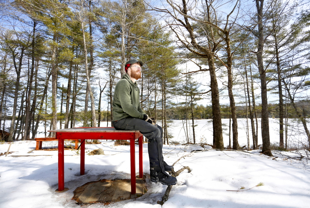 Andy McEvoy, director of Hidden Valley Nature Center, one of the five land conservation organizations proposing to merge, sits at the location for a new lakeside cabin on Little Dyer Pond at the center in Jefferson in this March 2014 file photo.