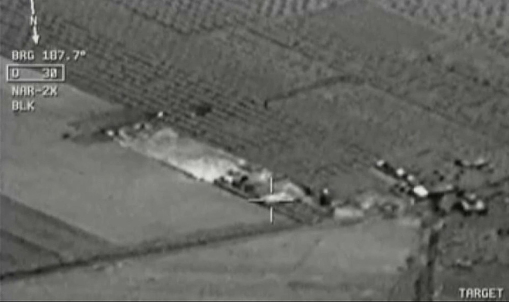 Image from aircraft cockpit video released by Turkey’s state-run agency Anadolu Friday, July 24, 2015, of what they report to be Turkish warplanes striking Islamic State group targets across the border in Syria. Black object at centre above target is bomb shortly before impact. Earlier a government official said three F-16 jets took off from Diyarbakir airbase in southeast Turkey early Friday and used smart bombs to hit three IS targets across the Turkish border province from Kilis.