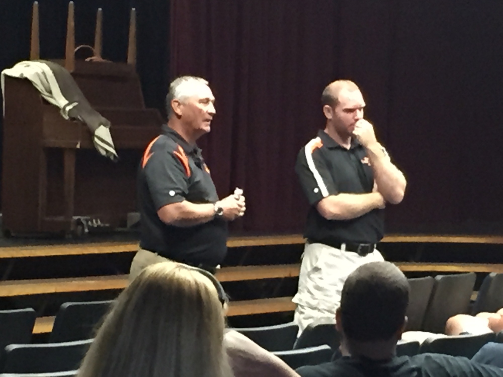 Staff photo by Randy Whitehouse 
 Gardiner athletic director Steve Ouellette, left, and new football coach Joe White talk to parents and players Saturday morning at the high school.