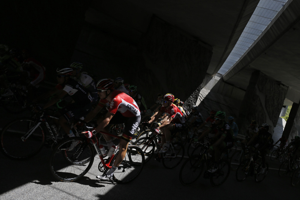 The pack passes through a tunnel during the twentieth stage of the Tour de France cycling race over 110.5 kilometers (68.7 miles) with start in Modane and finish in Alpe d’Huez, France, Saturday.