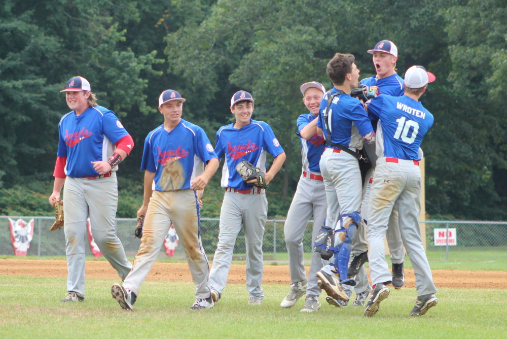 Members of the Augusta 15U Babe Ruth team celebrate their 2-1 victory over Cranston, R.I., on Sunday morning at Trumbull High School in Trumbull, Conn.