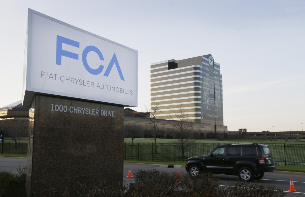 In this Tuesday, May 6, 2014, file photo, the Fiat Chrysler Automobiles sign is seen after being unveiled at Chrysler World Headquarters in Auburn Hills, Mich.