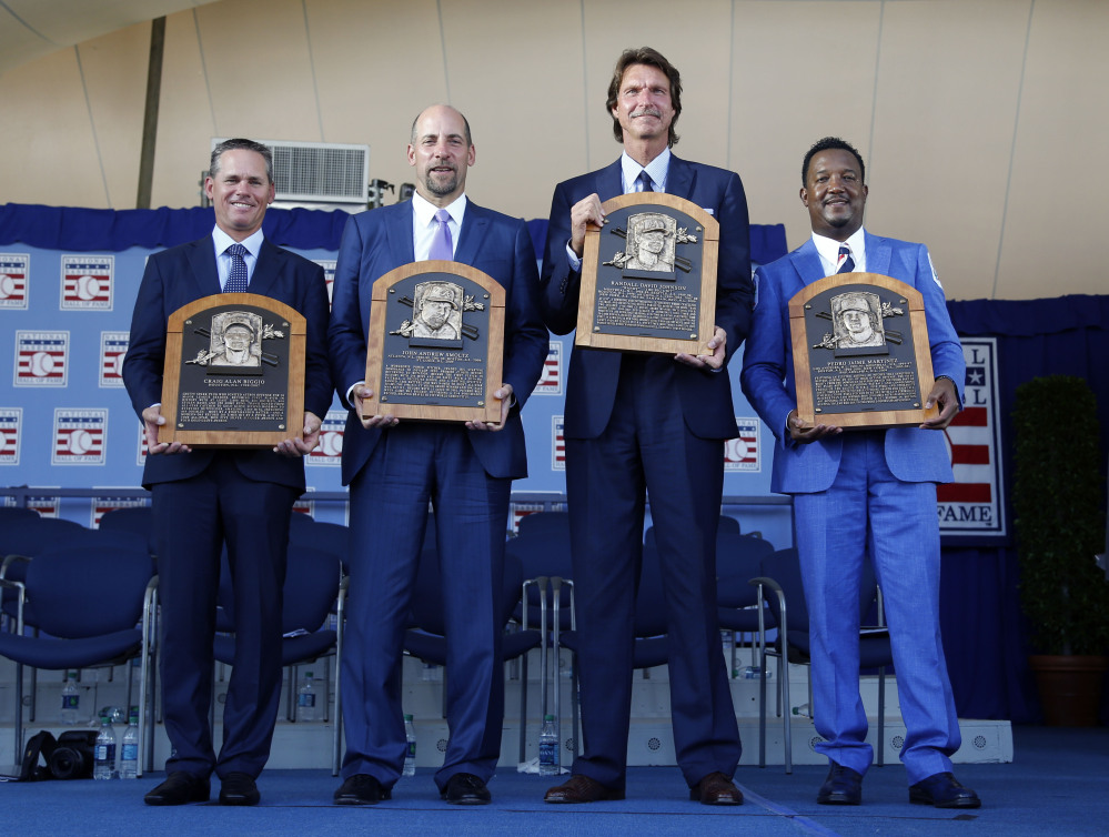Newly-inducted National Baseball Hall of Famers  from left: Craig Biggio, John Smoltz, Randy Johnson and Pedro Martinez hold their plaques after an induction ceremony.