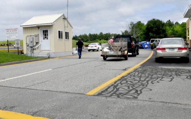Residents arrive to drop off material debris, recyclable items and trash at the China transfer station on Monday. Selectmen are considering a pay-as-you-throw program.