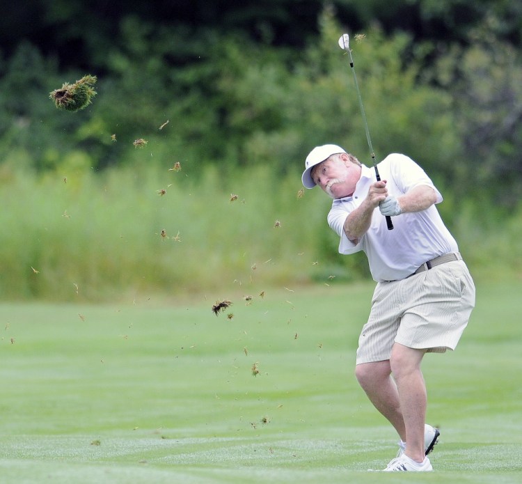 Mark Plummer, of Manchester, hits Monday on to a green during first round play Monday at the annual Charlie's Maine Open at the Augusta Country Club in Manchester. 