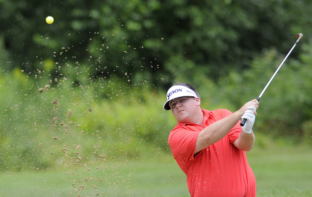 Ryan Gay, of Pittston, hits a ball out of a bunker during the the first round of the Charlie’s Maine Open on Monday at the Augusta Country Club in Manchester.