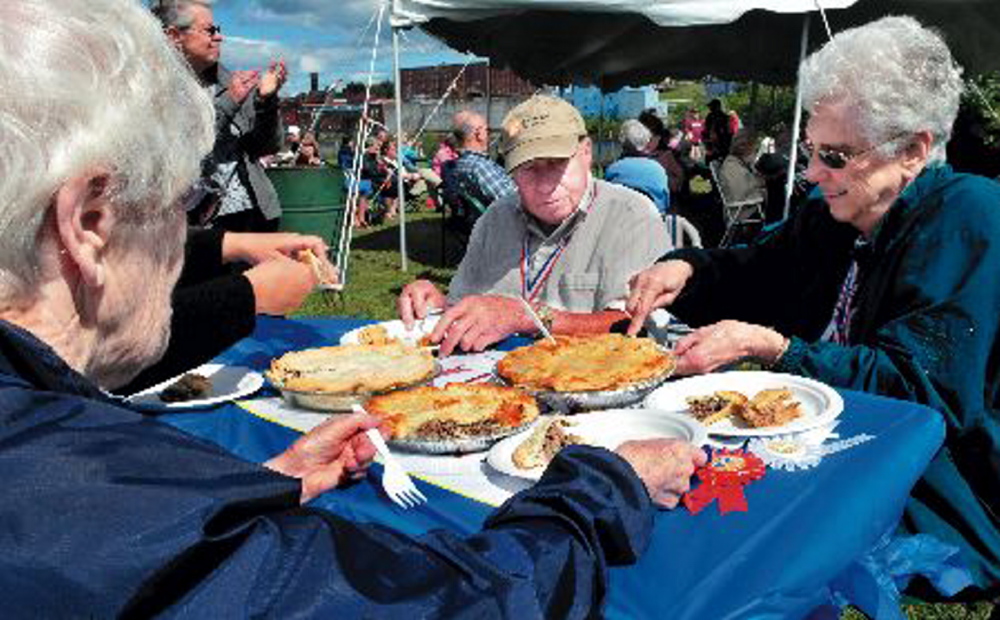 Judges sample toutiere during a competition at the 2013 Franco-American Festival in Waterville. The traditional French foods remained as the festival last year became the multi-cultural Festival at the Falls. The city cut funding to the festival this year, but organizers hope contributions will keep it alive.