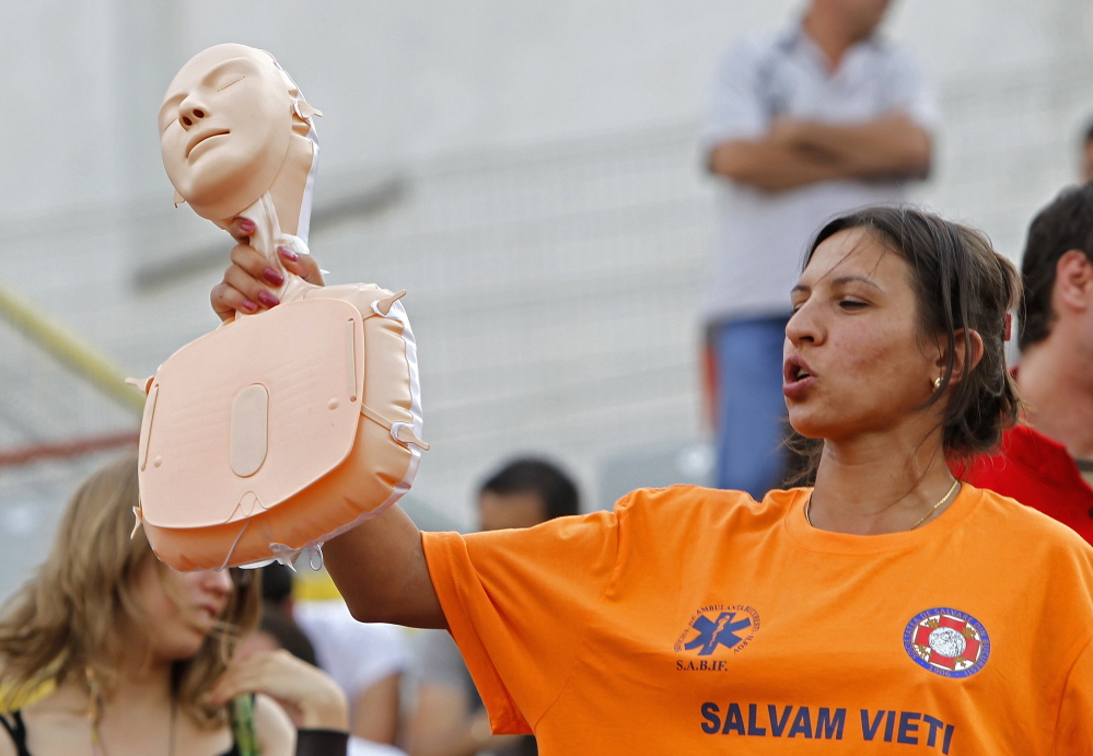 A paramedic holds a plastic CPR training mannequin while teaching volunteers how to perform CPR in Romania in 2011. While some countries mandate CPR training, less than 3 percent of the U.S. population receives instruction.
Reuters