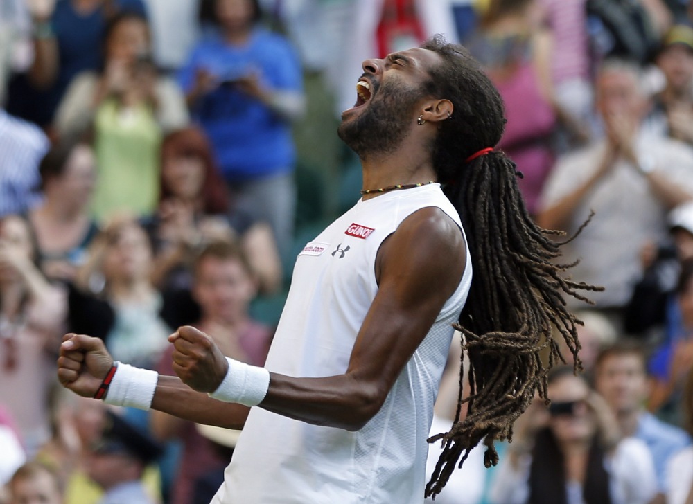 Dustin Brown of Germany celebrates after defeating Rafael Nadal of Spain in their singles match at the All England Lawn Tennis Championships in Wimbledon, London, on Thursday.